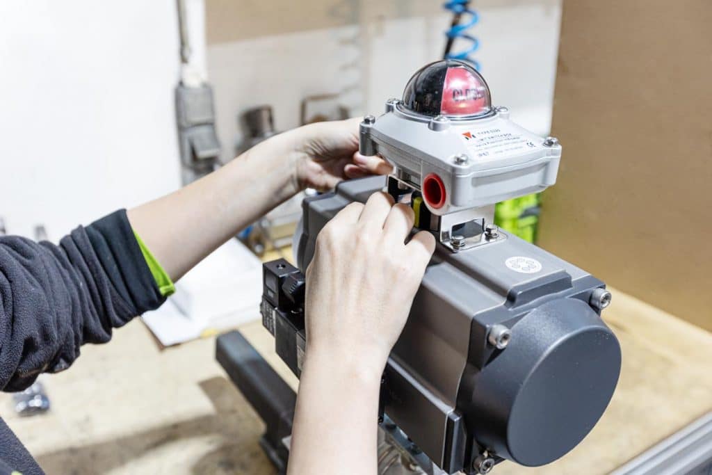 Ball valve with bracket, adapter, pneumatic actuator and limit switch during the modification and automation of an industrial valve