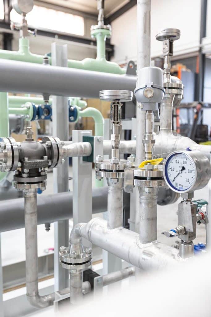 Stainless steel pipelines with control valve and pressure gauge from pipeline and plant construction